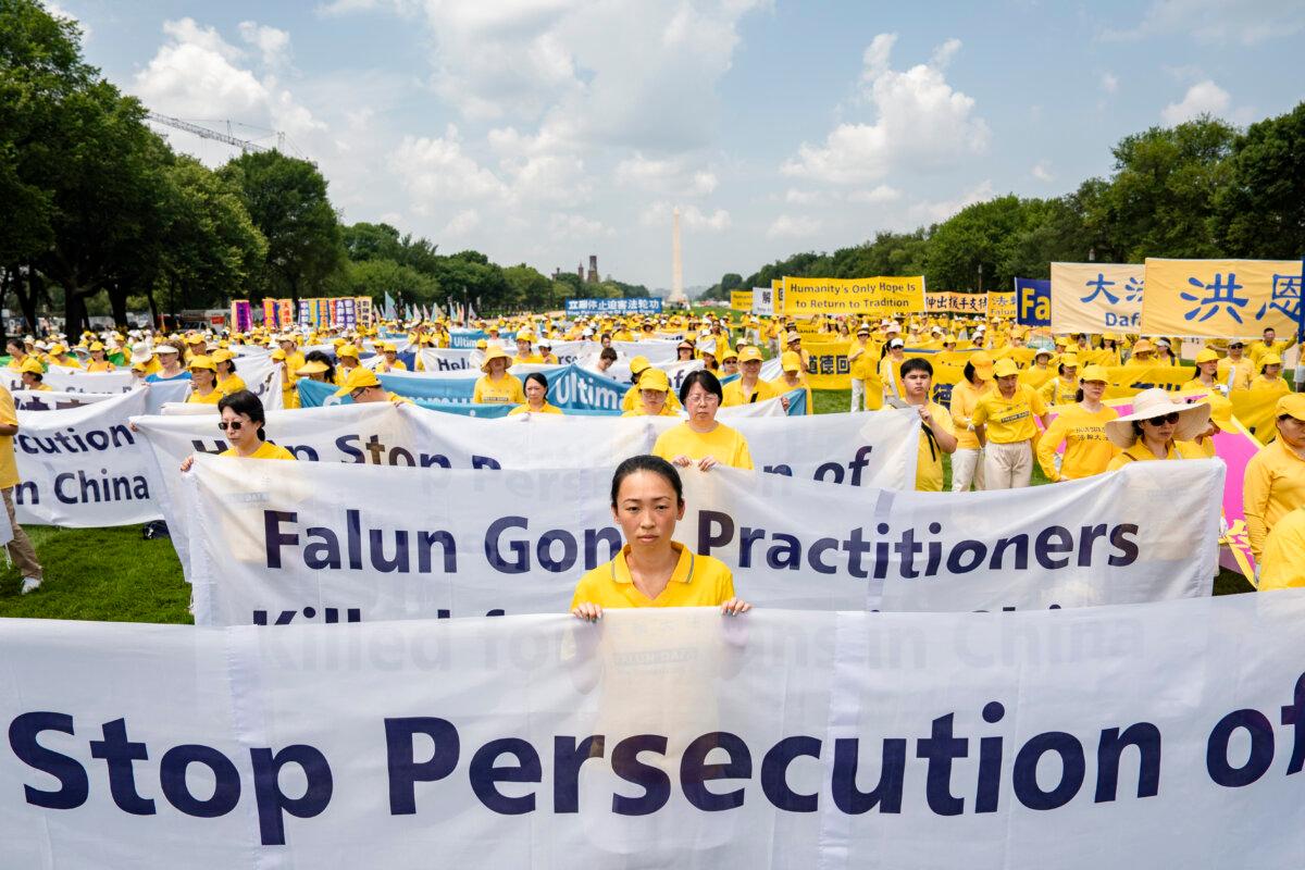 Falun Gong practitioners call for an end to the persecution of the spiritual group in China, during an event marking 24 years since the launch of the persecution, on Capitol Hill, on July 20, 2023. (Samira Bouaou/The Epoch Times)