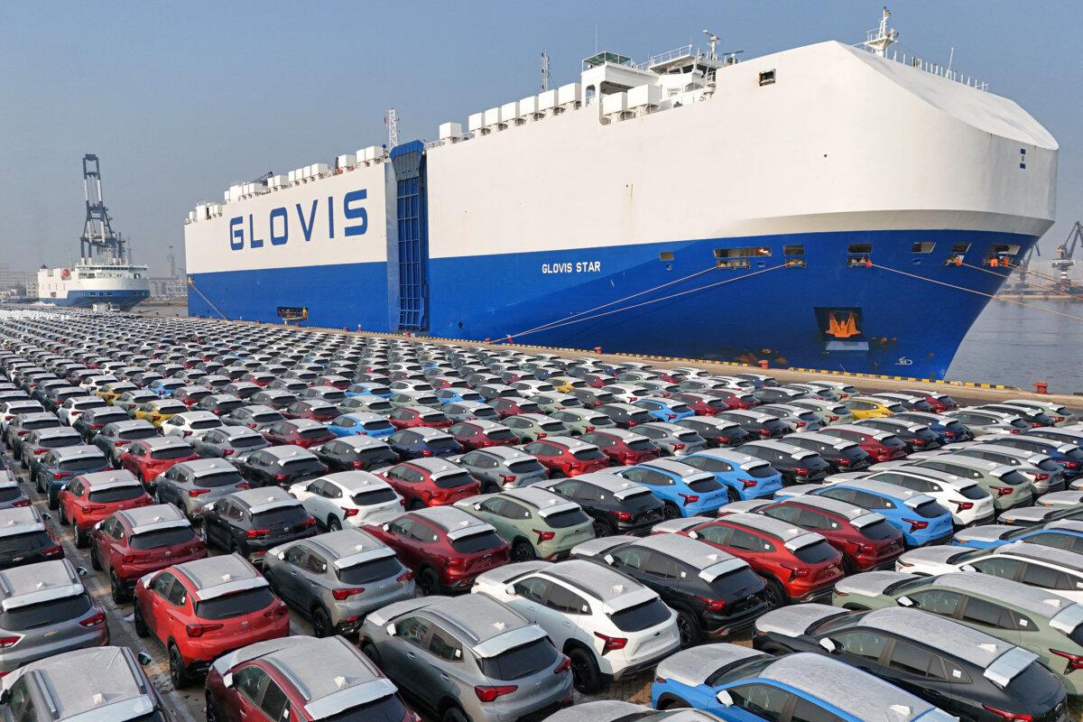 Cars wait to be loaded onto a ship for export at the port in Yantai, in China's eastern Shandong province on January 2, 2024. (STR/AFP via Getty Images)