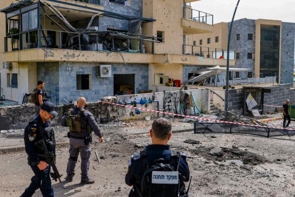 Israeli forces check a building that was hit by a Hezbollah rocket in Kiryat Shmona in northern Israel, near the Lebanon border, on March 27, 2024. (JALAA MAREY/AFP via Getty Images)