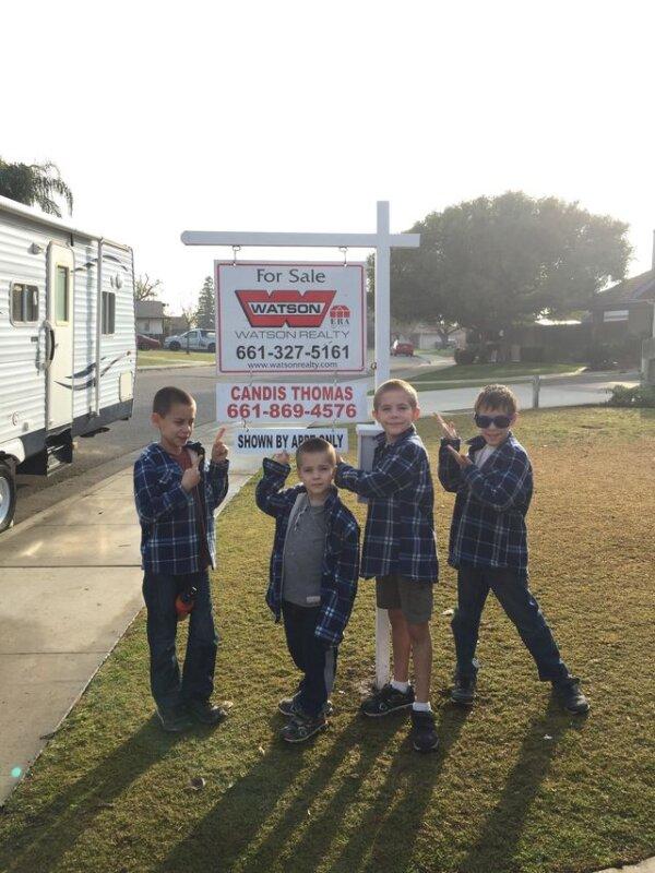 The Hollar boys with the "For sale" sign for their California home. (Courtesy of Meg and Ben Hollar)