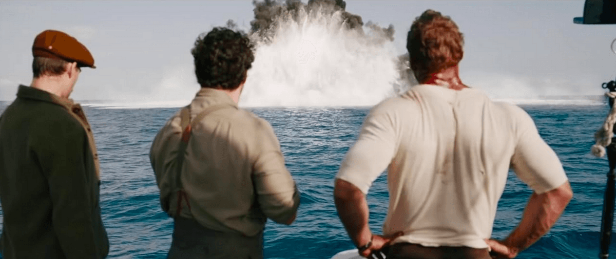 (L–R) Henry Hayes (Hero Fiennes Tiffin), Gus March-Phillipps (Henry Cavill), and Anders Lassen (Alan Ritchson) observe the work of their demolition-expert teammate in "The Ministry of Ungentlemanly Warfare." (Jerry Bruckheimer Films/Lionsgate)