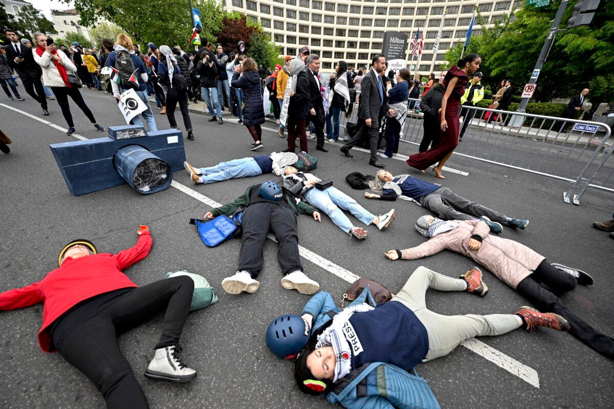 Demonstrators lay in the street during a pro-Palestinian protest over the Israel–Hamas war before the White House Correspondents' Association Dinner at the Washington Hilton in Washington on April 27, 2024. (Terrance Williams/AP Photo)