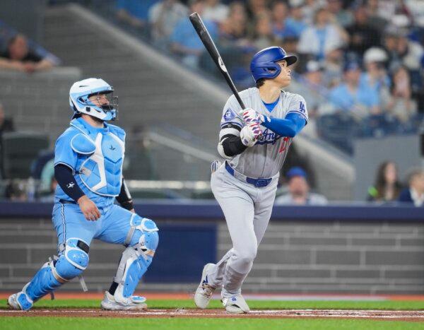 Shohei Ohtani (17) of the Los Angeles Dodgers flies out against in front of Alejandro Kirk (30) of the Toronto Blue Jays during the first inning in their MLB game in Toronto on April 28, 2024. (Mark Blinch/Getty Images)
