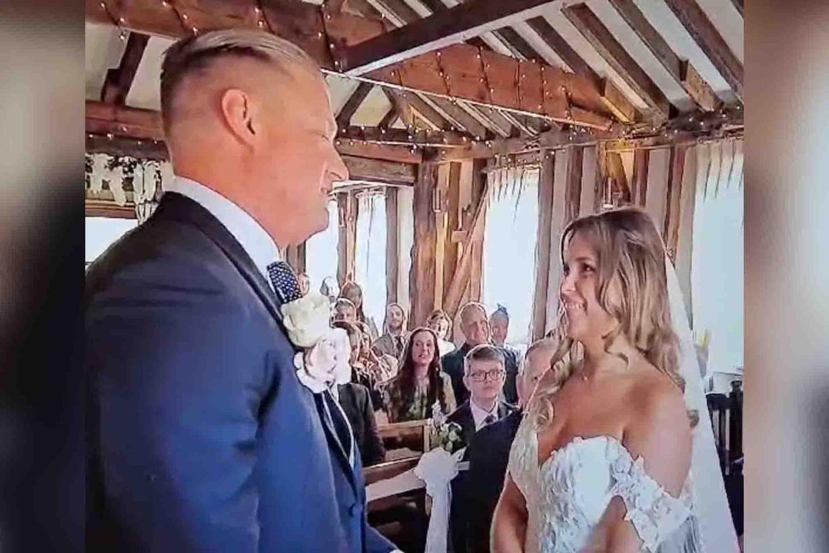 A couple stands at the altar, ready to take their vows. (Screenshot/Newsflare)