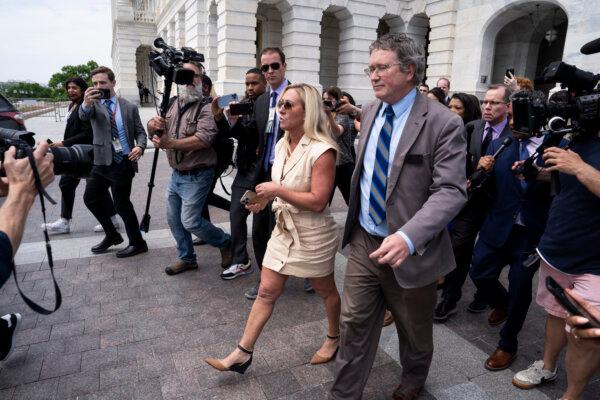 Rep. Marjorie Taylor Greene (R-Ga.) (C) and Rep. Thomas Massie (R-Ky.) (R) walk outside the U.S. Capitol in Washington on April 30, 2024. (Madalina Vasiliu/The Epoch Times)