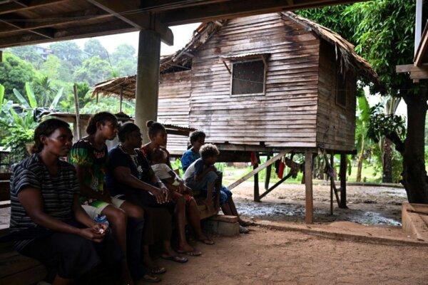 This picture taken on April 17, 2024, shows a family spending their afternoon in the open at Fulisango village in Honiara, the capital city of Solomon Islands. In the coming days, politicians with common interests will start to coalesce into "camps" based in Honiara's casinos and hotels—seeking to form a ruling majority. (Saeed Khan/Getty Images)