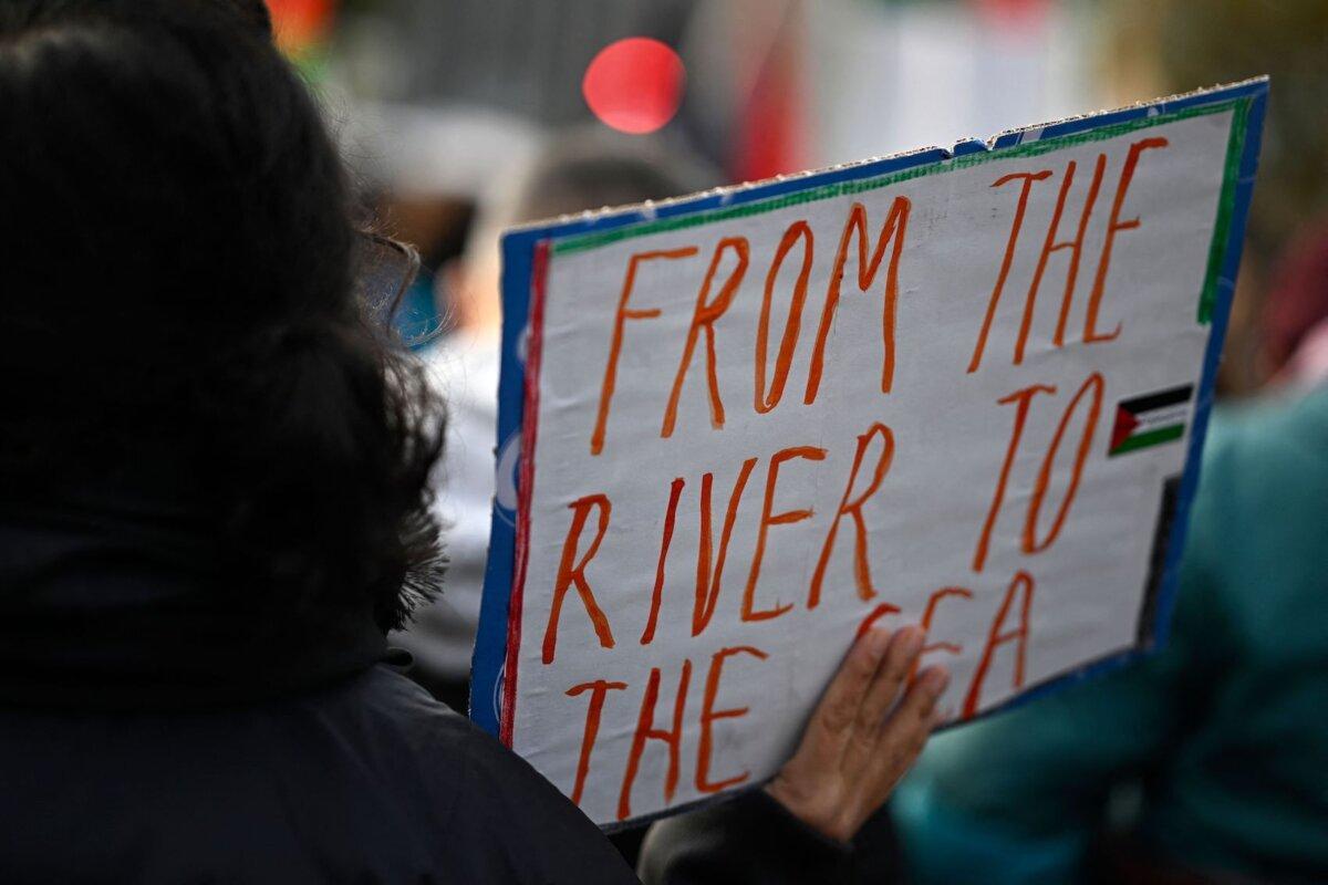 A demonstrator displays a placard with the lettering 'From the river to the sea' during a rally in solidarity with Palestinians at Oranienplatz Square in Berlin's Kreuzberg district, Germany, on Nov. 11, 2023. (Tobias Schwarz/AFP via Getty Images)