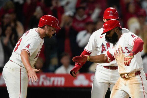 Los Angeles Angels' Luis Rengifo (R) celebrates with Brandon Drury (L) and Taylor Wards (C) after hitting a three-run home run during the sixth inning of a baseball game against the Philadelphia Phillies in Anaheim, Calif., on April 30, 2024. (Ryan Sun/AP Photo)