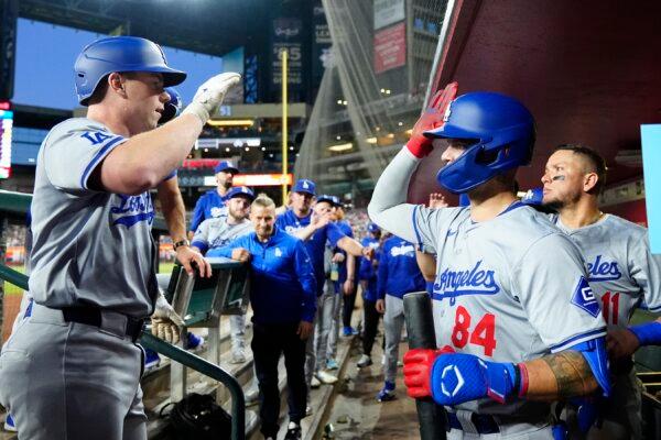 Los Angeles Dodgers' Will Smith (L) celebrates his home run against the Arizona Diamondbacks with Dodgers' Andy Pages (84) and Miguel Rojas (11) during the third inning of a baseball game in Phoenix on May 1, 2024. (Ross D. Franklin/AP Photo)
