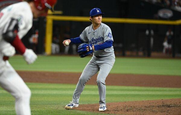 Yoshinobu Yamamoto (18) of the Los Angeles Dodgers makes a play on a ground ball by Jake McCarthy (31) of the Arizona Diamondbacks during the third inning at Chase Field in Phoenix on May 1, 2024. (Norm Hall/Getty Images)