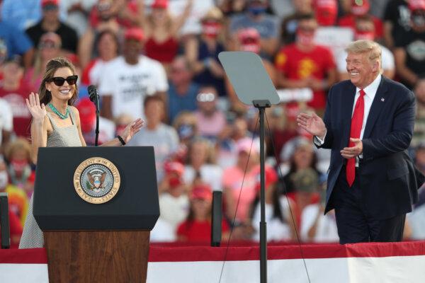 President Donald Trump laughs as Hope Hicks, a senior adviser to the president, speaks to the crowd after the president brought her on stage during a campaign event at the Ocala International Airport on Oct. 16, 2020, in Ocala, Florida. (Joe Raedle/Getty Images)