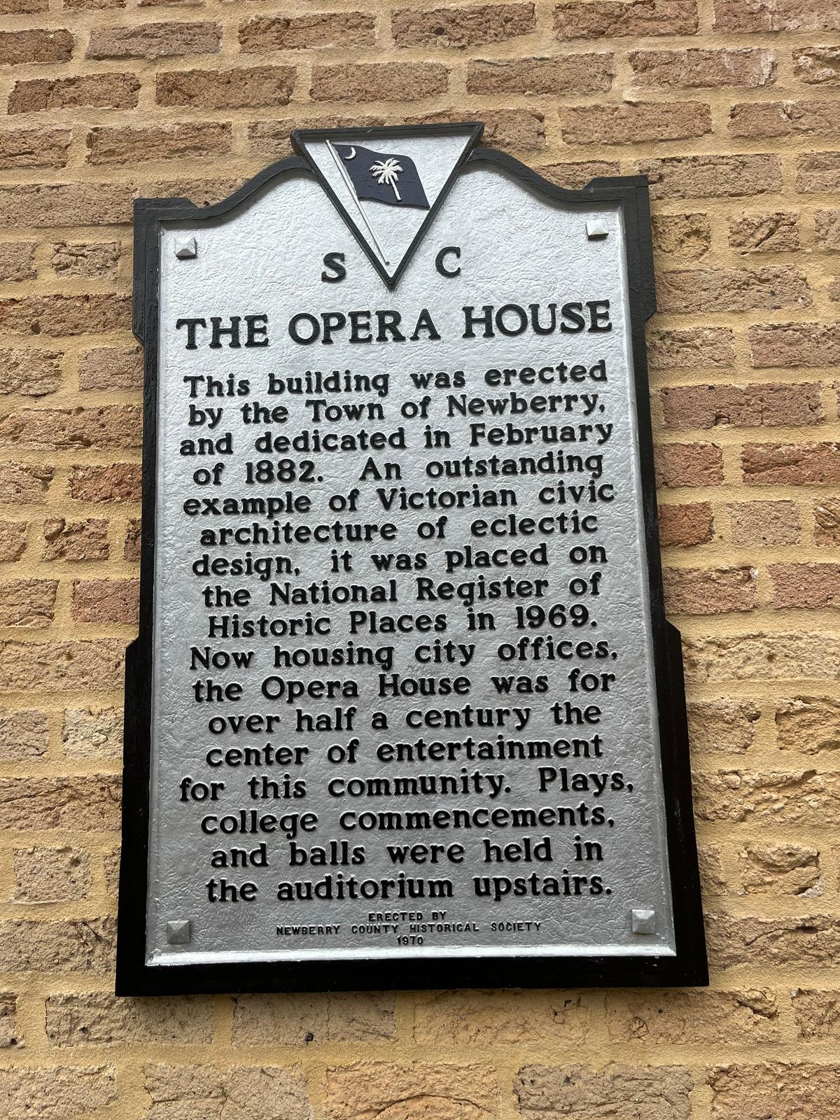 The historical plaque on the outside of the Newberry Opera House commemorates its importance to the community. (Deena Bouknight)
