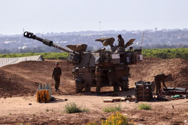 Israeli troops man a position with a mobile artillery unit near the border with the Gaza Strip on May 8, 2024. (Jack Guez/AFP via Getty Images)