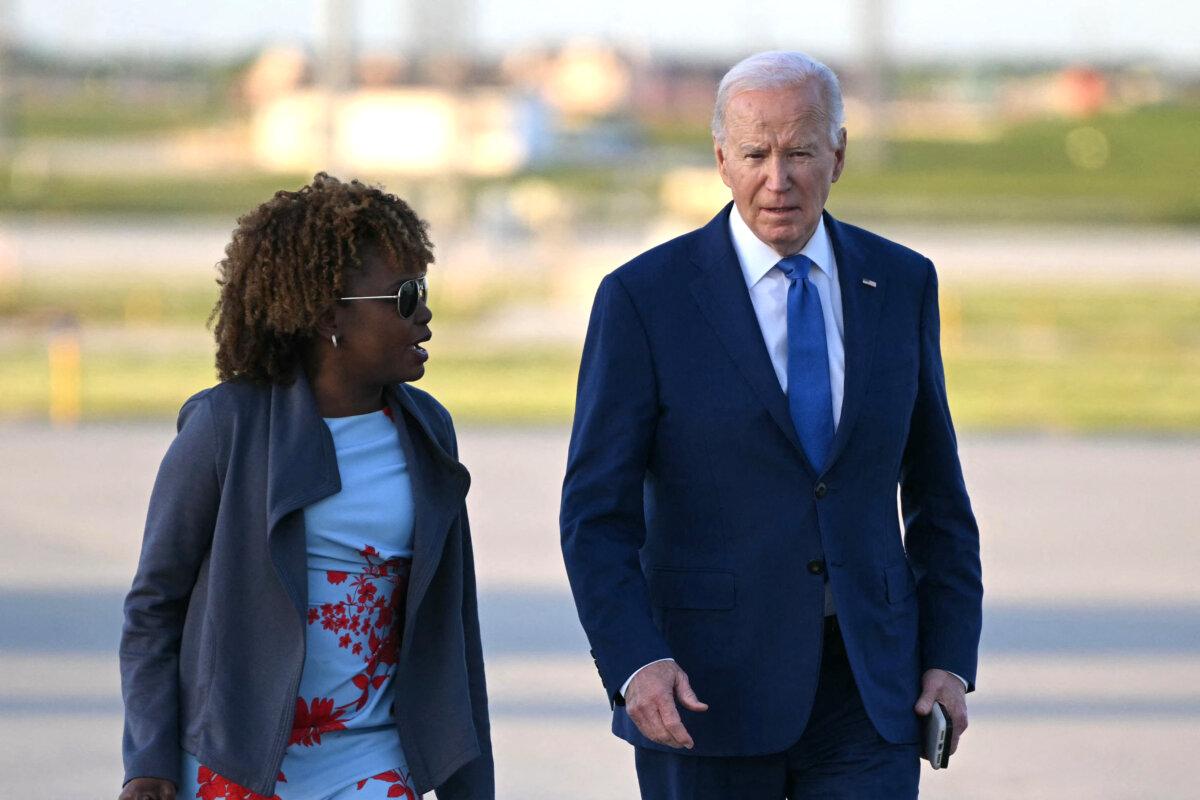 US President Joe Biden walks with White House Press Secretary Karine Jean-Pierre as he makes his way to board Air Force One before departing Chicago O’Hare International Airport in Chicago, Illinois on May 8, 2024. Biden was in Chicago to attend a campaign event. (Photo by Mandel NGAN / AFP)