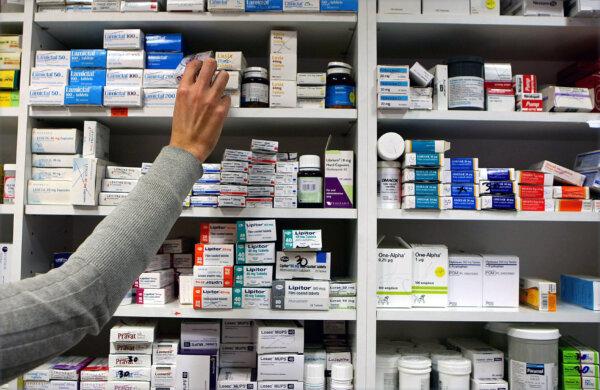 A pharmacist stocks shelves at a chemist in a file photo on Nov. 16, 2009. (Julien Behal/PA Wire)