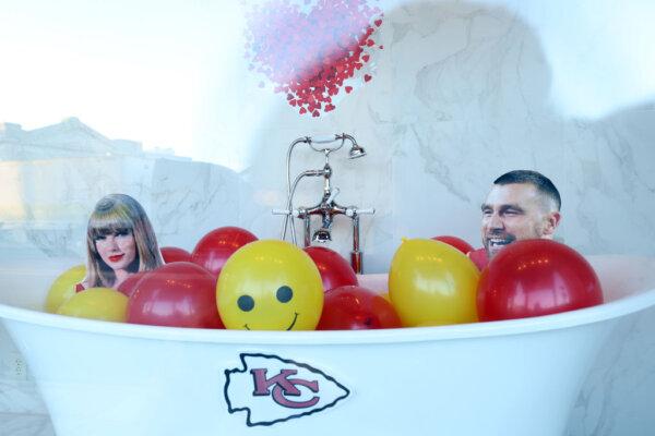 A store window displays cardboard cutouts of Travis Kelce #87 and Taylor Swift during the Kansas City Chiefs Super Bowl LVIII victory parade in Kansas City, Mo., on Feb. 14, 2024. (Jamie Squire/Getty Images)