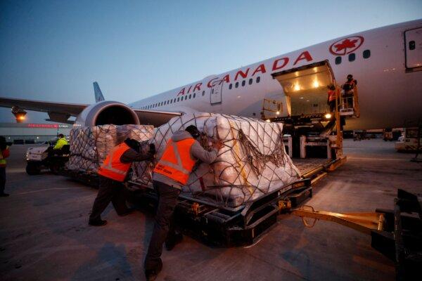 A Warsaw-bound cargo plane is loaded with humanitarian aid, including medical supplies destined for Ukraine, at Pearson International Airport in Toronto on March 9, 2022. (Cole Burston/AFP via Getty Images)