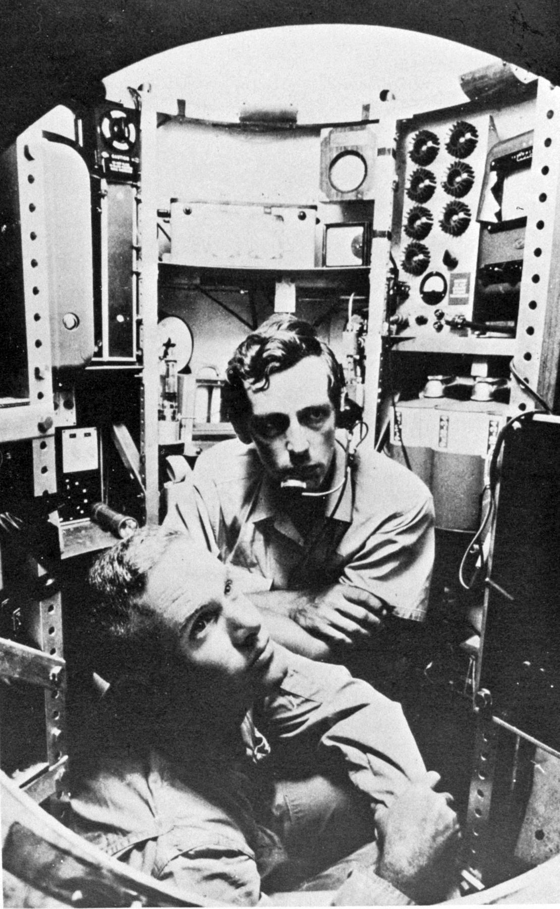 Don Walsh (L) and Jacques Piccard in the Bathyscaphe Trieste. (Public Domain)