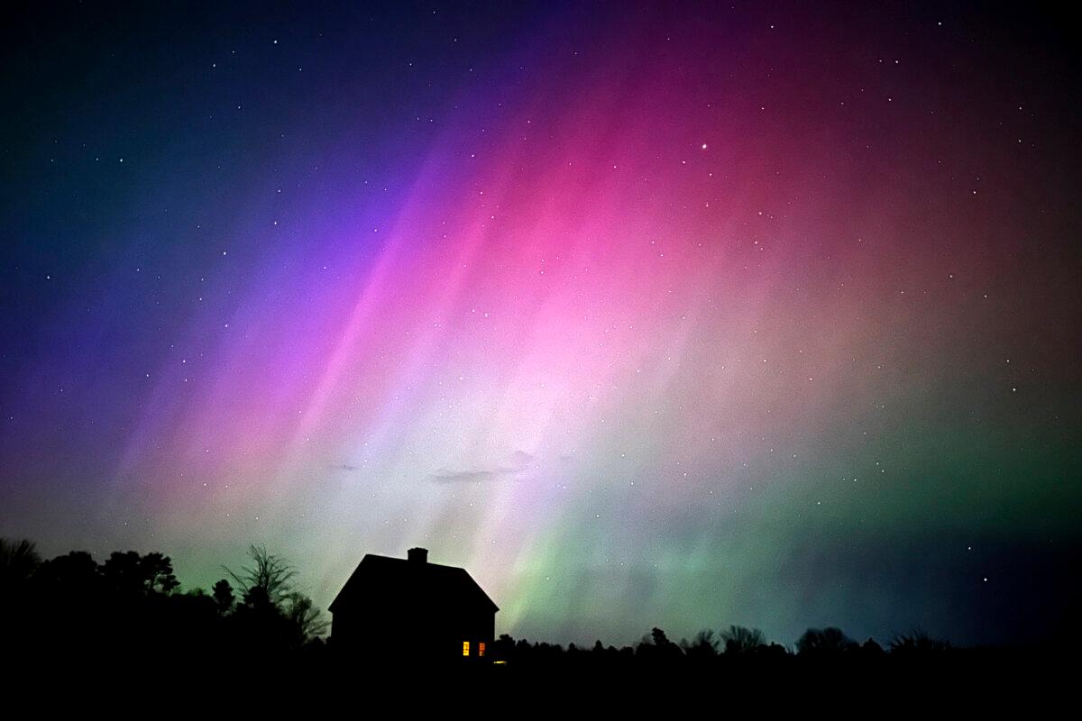 The northern lights flare in the sky over a farmhouse in Brunswick, Maine, late on May 10, 2024. (Robert F. Bukaty/AP Photo)