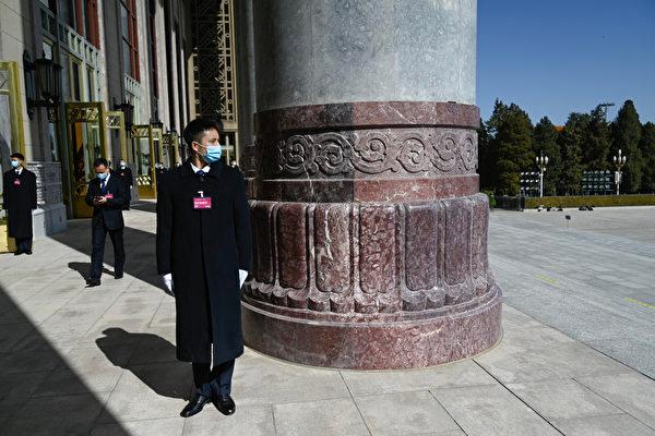 Security personnel are seen before the second plenary session of the 14th National People's Congress (NPC) at the Great Hall of the People in Beijing, on March 8, 2024. (Pedro Pardo/AFP via Getty Images)