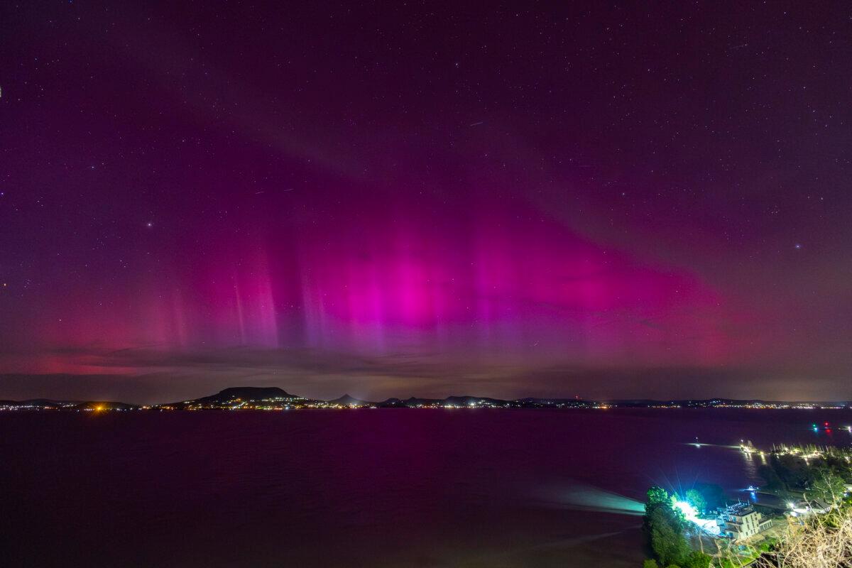 The Northern Lights, or Aurora Borealis, illuminate the night sky over the Lake Balaton, near Fonyod, Hungary, late on May 10, 2024. (Gyorgy Varga/MTI via AP)