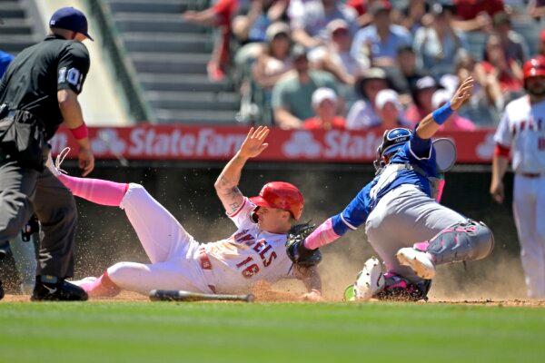 Mickey Moniak (16) of the Los Angeles Angels beats the tag by Freddy Fermin (34) of the Kansas City Royals for a run in the sixth inning at Angel Stadium in Anaheim, Calif., on May 12, 2024. (Jayne Kamin–Oncea/Getty Images)