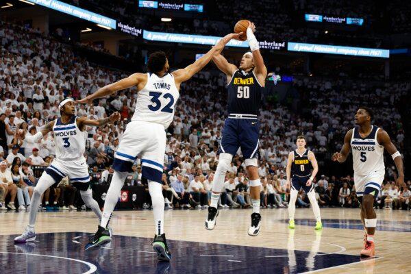 Aaron Gordon (50) of the Denver Nuggets takes a shot over Karl-Anthony Towns (32) of the Minnesota Timberwolves during the fourth quarter in Game Four of the Western Conference Second Round Playoffs in Minneapolis on May 12, 2024. (David Berding/Getty Images)