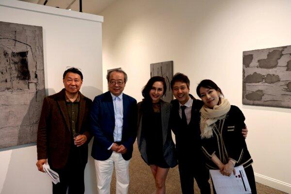 Artist Moon Insoo (2nd L) photographed with visitors at his exhibition “Revealing: Moon Insoo” at Gallery Chang in Middletown, N.Y. on May 10, 2024. (The Epoch Times)