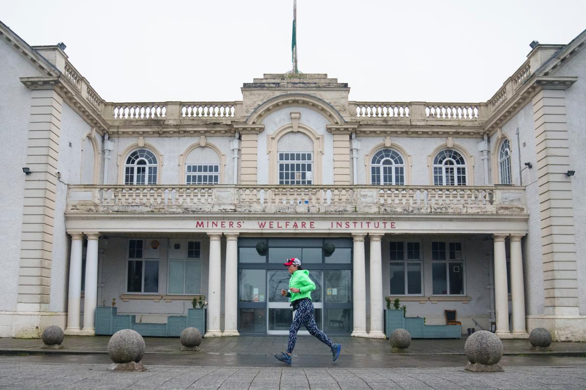 Ms. Ryvar passes the Miners' Welfare Institute in Wrexham during a half marathon in Wrexham, Wales. (Jon Super/AP Photo)