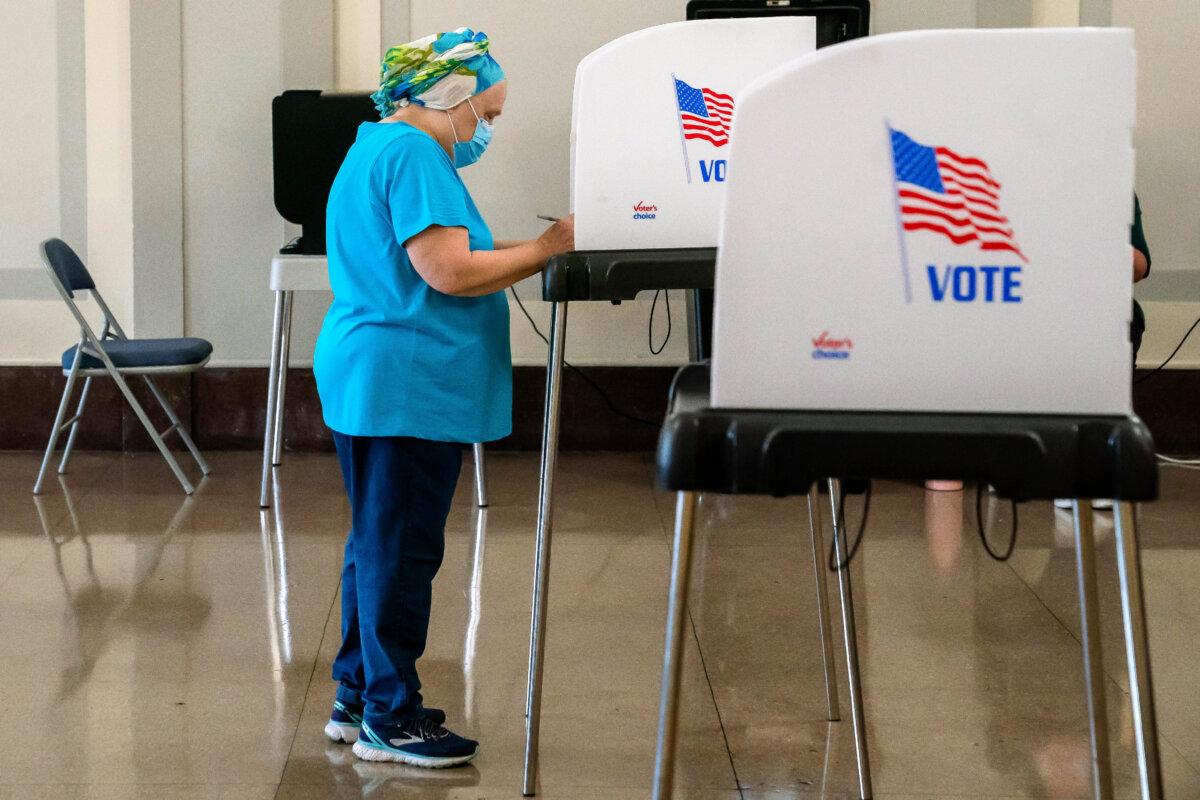 A voter casts their ballot at a polling place at the Baltimore War Memorial Building during the midterm primary election in Baltimore, Md., on July 19, 2022. (Nathan Howard/Getty Images)