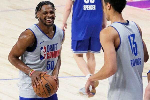 Bronny James (L) smiles as he participates in the NBA Draft Combine in Chicago on May 14, 2024. (Nam Y. Huh/AP Photo)