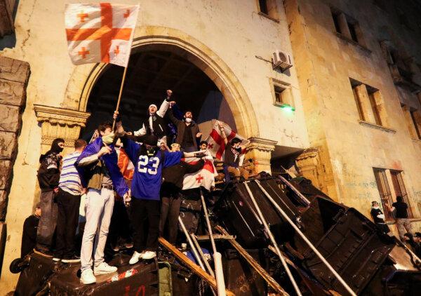 Protesters barricade the entrance of parliament during a rally to protest against a 'foreign agents' bill, in Tbilisi, Georgia, on May 2, 2024. (Irakli Gedenidze/Reuters)