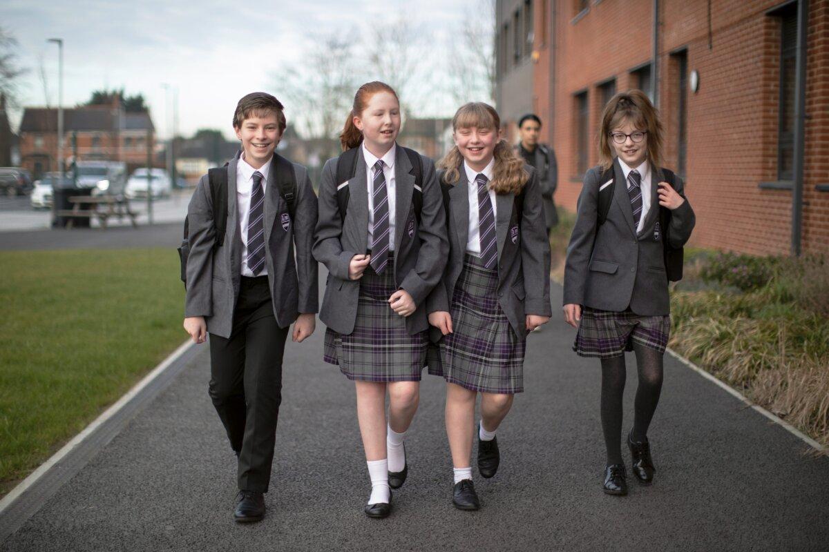 Pupils arrive at Chertsey High School in Chertsey, England, on March 9, 2021. (Dan Kitwood/Getty Images)