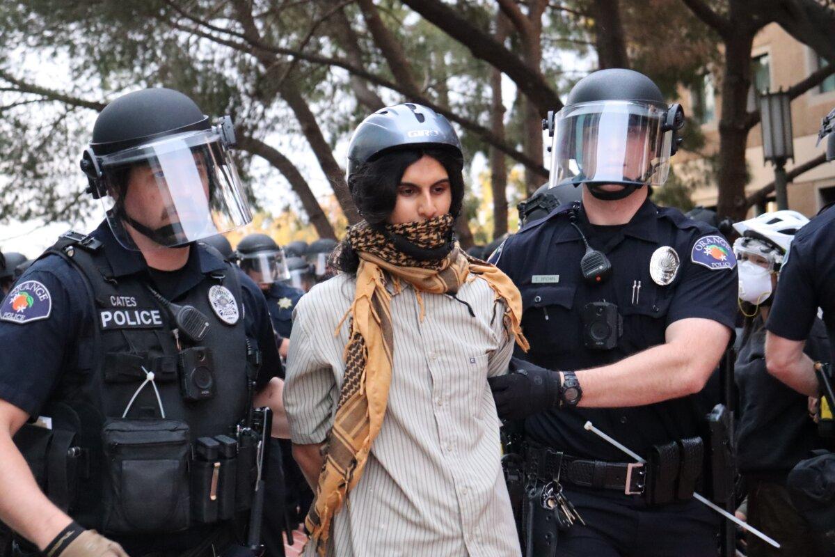 Law enforcement officers arrest a person during a pro-Palestinian protest at the University of California–Irvine on May 15, 2024. (May He/The Epoch Times)