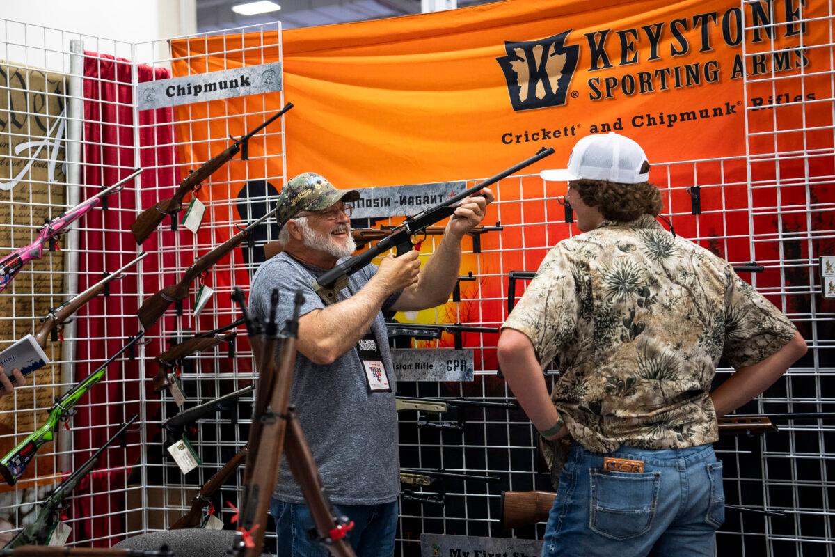 People try firearms at the 2024 National Rifle Association (NRA) exhibits at the Kay Bailey Hutchison Convention Center in Dallas, Texas, on May 17, 2024. (Madalina Vasiliu/The Epoch Times)