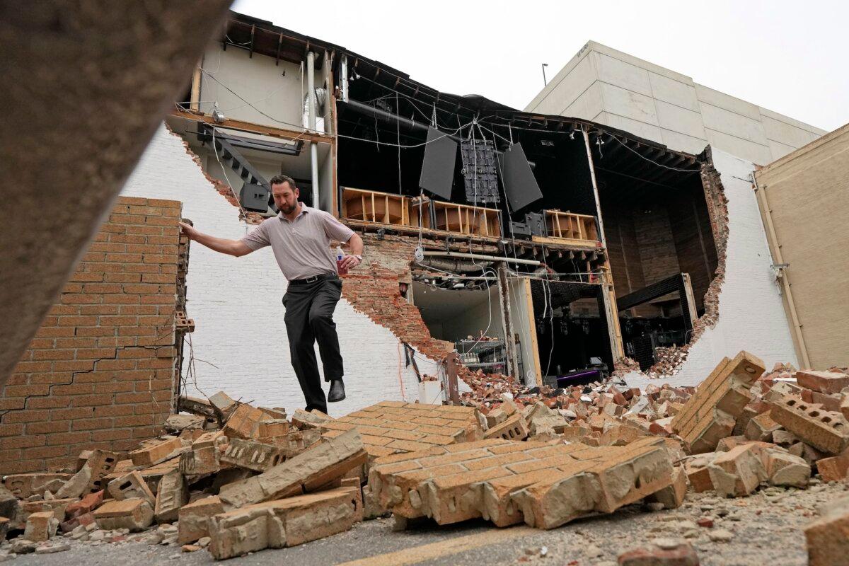 A man walks over fallen bricks from a damaged building in the aftermath of a severe thunderstorm in Houston on May 17, 2024. (David J. Phillip/AP Photo)