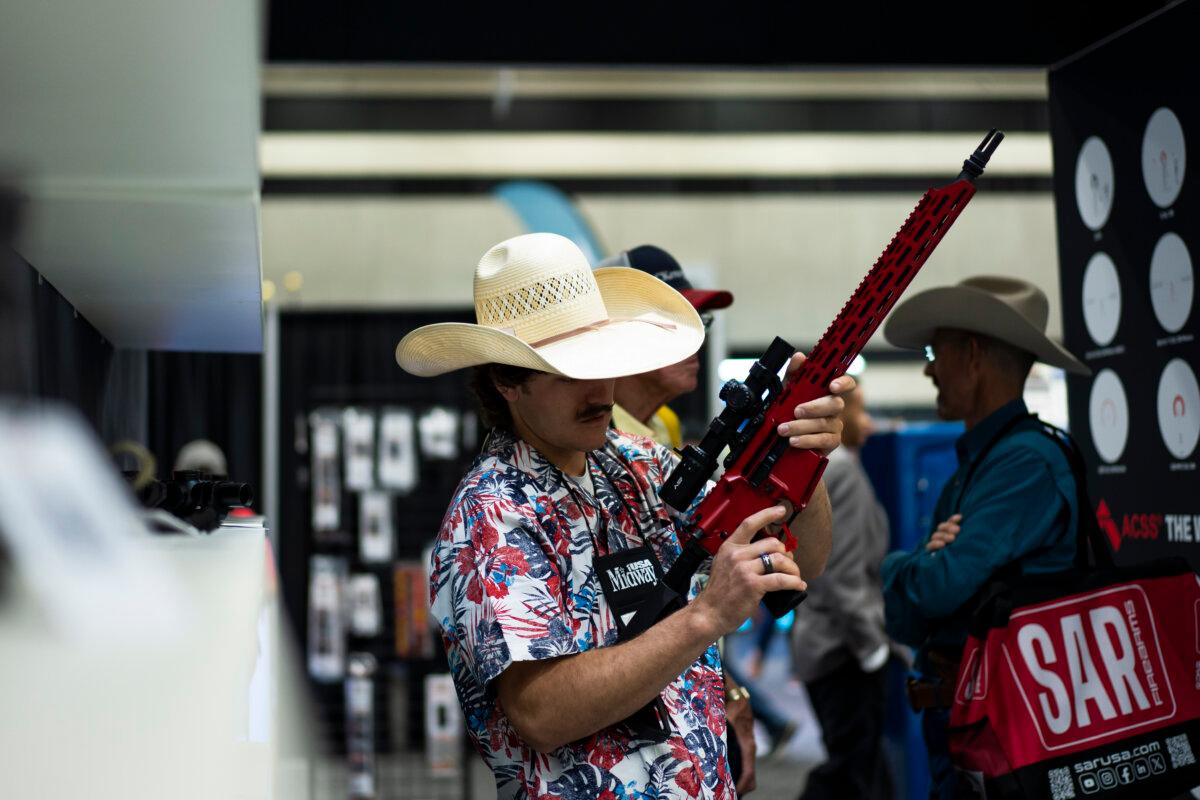People try out firearms at the National Rifle Association exhibits at the Kay Bailey Hutchison Convention Center in Dallas on May 18, 2024. (Madalina Vasiliu/The Epoch Times)