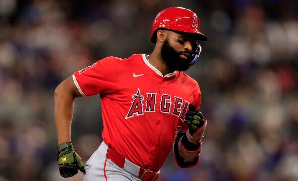 Jo Adell (7) of the Los Angeles Angels rounds the bases after hitting a solo home run against the Texas Rangers during the seventh inning in Arlington, Texas, on May 18, 2024. (Ron Jenkins/Getty Images)