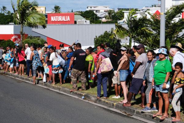 People queue to enter a supermarket to purchase groceries and food in the Magenta district of Noumea, France's Pacific territory of New Caledonia, on May 18, 2024. (Theo Rouby/AFP via Getty Images)