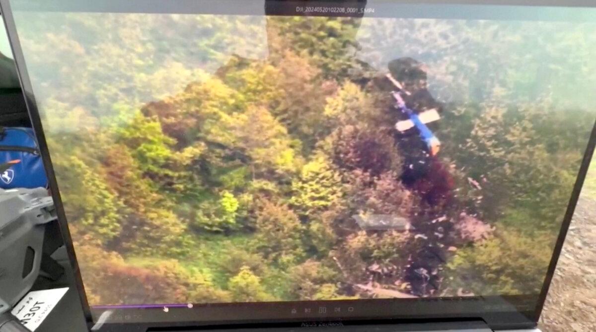 A mobile phone screen shows the crash site of the helicopter that carried Iranian President Ebrahim Raisi, in East Azerbaijan Province, Iran, on May 20, 2024. (Pool via WANA via Reuters/Screenshot via The Epoch Times)