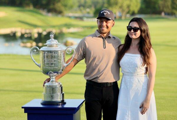 Xander Schauffele of the United States poses with his wife, Maya Schauffele, and the Wanamaker Trophy after winning the 2024 PGA Championship in Louisville, Ky., on May 19, 2024. (Andy Lyons/Getty Images)