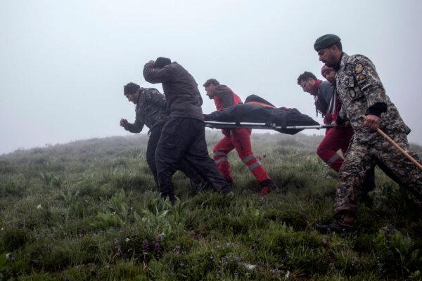Rescuers recover bodies at the crash site of a helicopter transporting Iran's president, his foreign minister, and others in Varzaghan in northwestern Iran, on May 20, 2024. (Azin Haghighi/AFP via Getty Images)
