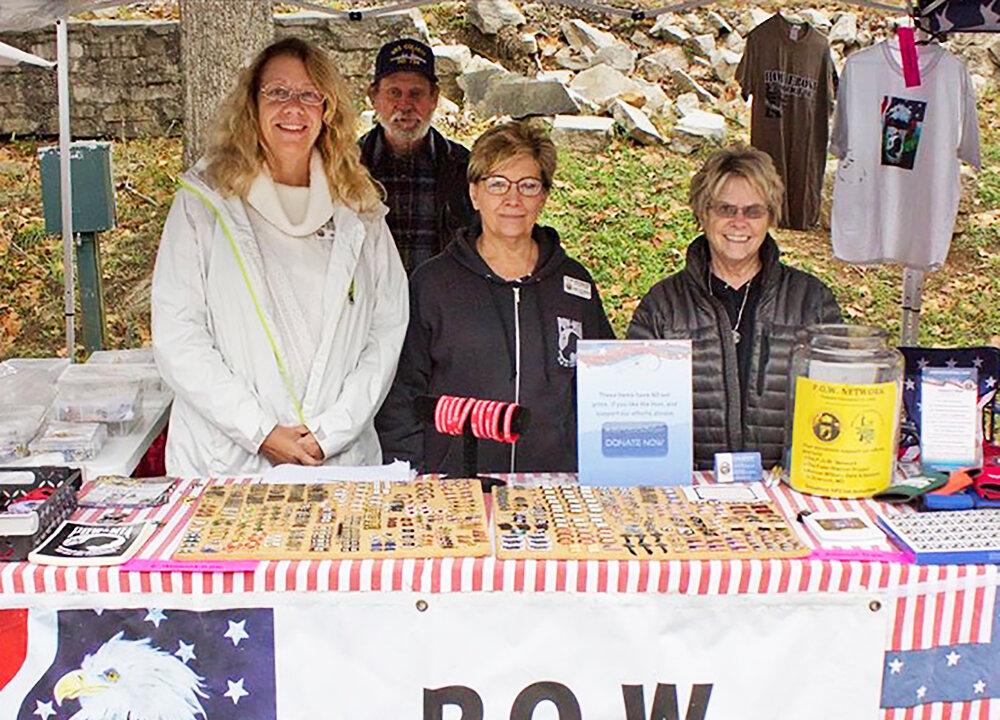 The POW Network participated in the Grape and Fall Festival in Hollister, Mo., on Oct. 8, 2022. Kristina Gilbert (L), Lt. David McAllister USN (Ret.) (2nd L), Mary Schantag (2nd R), and Jeanne Cooper (R). (Courtesy of Mary Schantag)
