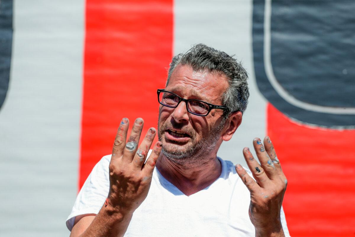 New York artist Scott LoBaido speaks after he unveils a 'Patriotic Lawn T' in support of former President Donald Trump in the area of Castleton Corners on Staten Island, N.Y., on Aug. 9, 2016. (Kena Betancur/AFP via Getty Images)