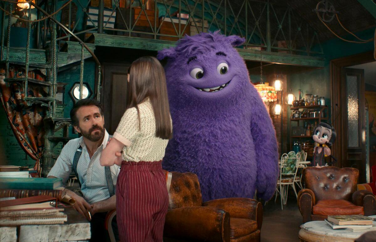 Ryan Reynolds (L), Cailey Fleming, the character Blue, voiced by Steve Carell, and the Blossom, voiced by Phoebe Waller-Bridge, in a scene from “IF.” (Paramount Pictures via AP)