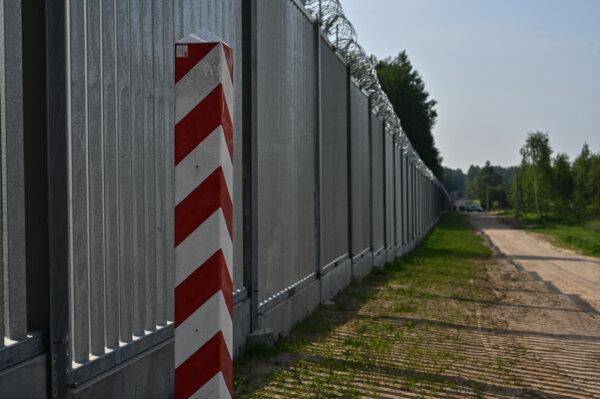 A Polish border marker at the metal border wall in Kuznica, Poland, on June 30, 2022, (Omar Marques/Getty Images)