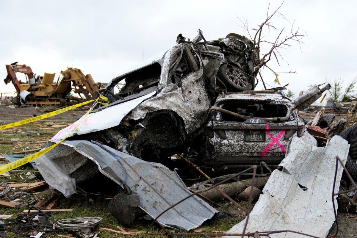 Damaged cars sit piled up next to a road after a tornado in Greenfield, Iowa, on May 21, 2024. (Charlie Neibergall/AP Photo)