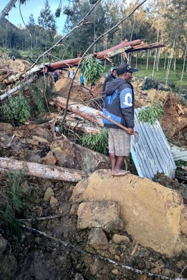 A man looks over the site of a landslide in Maip Mulitaka in Papua New Guinea's Enga Province on May 24, 2024. Local officials and aid groups said a massive landslide struck a village in Papua New Guinea's highlands on May 24, with many feared dead. (STR/AFP via Getty Images)