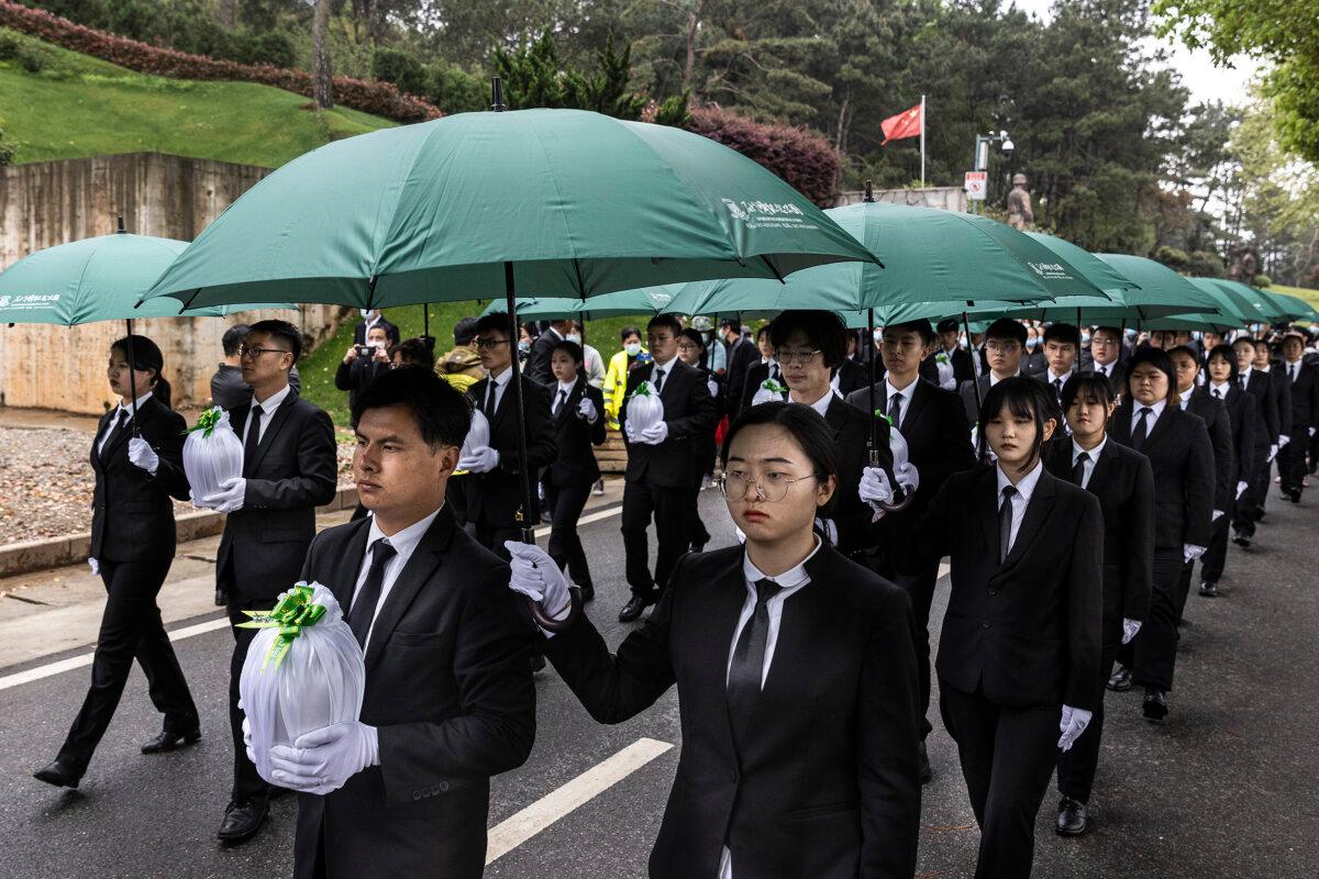 Cemetery employees attend an eco-friendly collective funeral ceremonial burial during Qingming Festival in Wuhan, Hubei Province, China, on April 3, 2021. (Getty Images)
