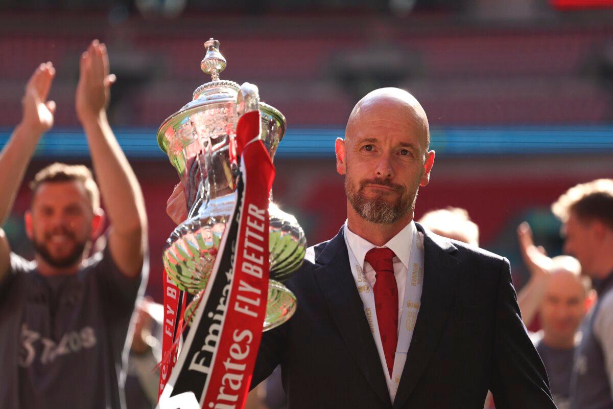 Manchester United's head coach Erik ten Hag celebrates with the trophy after winning the English FA Cup final soccer match between Manchester City and Manchester United at Wembley Stadium in London on May 25, 2024. (Ian Walton/AP Photo)